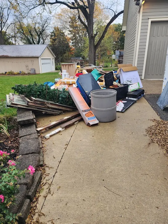 Dumpster being loaded with debris for Estate Cleanout Dumpster Rental in Fort Lee